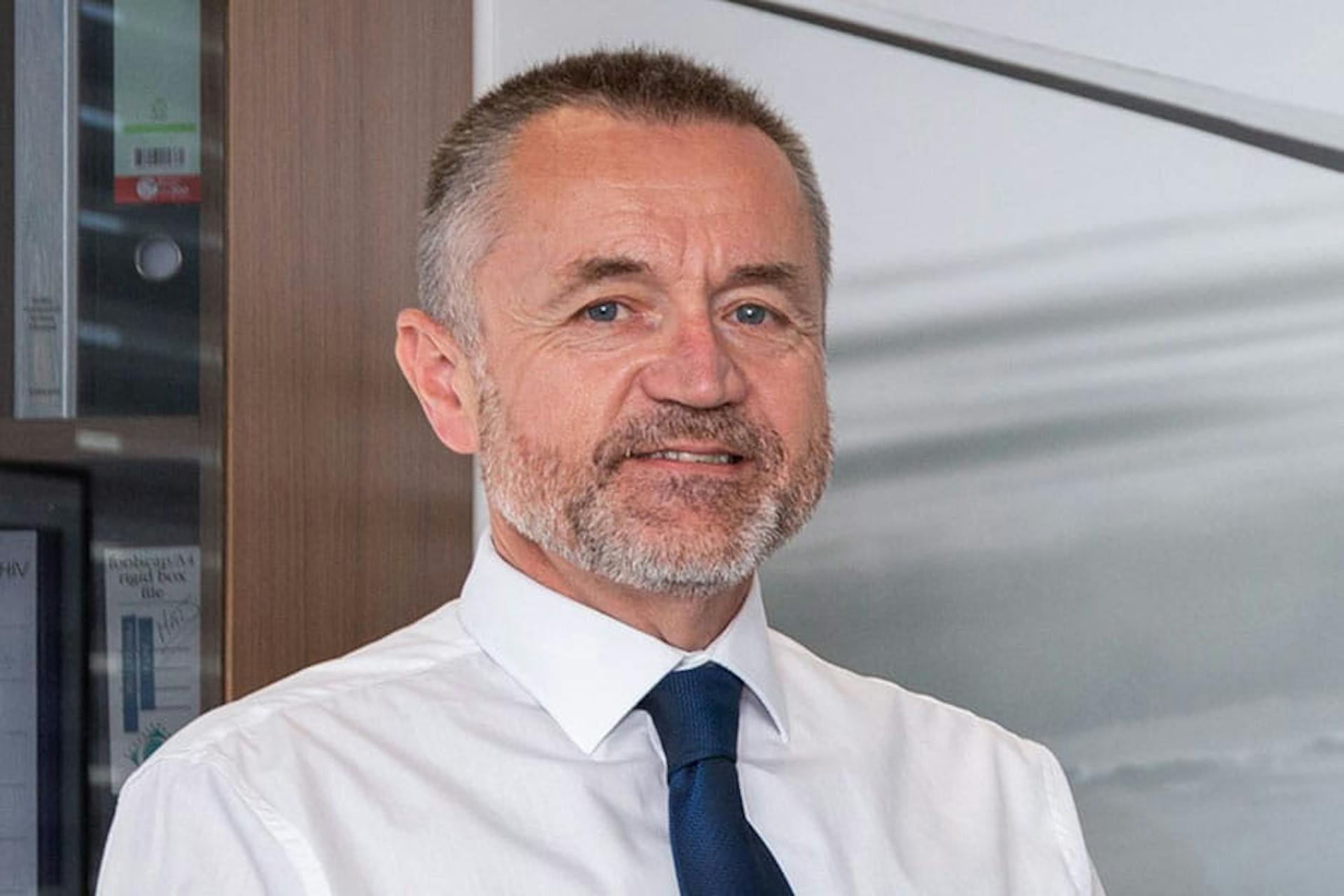 Clive Richardson portrait with white shirt and dark blue tie