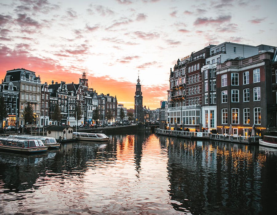 Amsterdam, buildings surround a river with boats