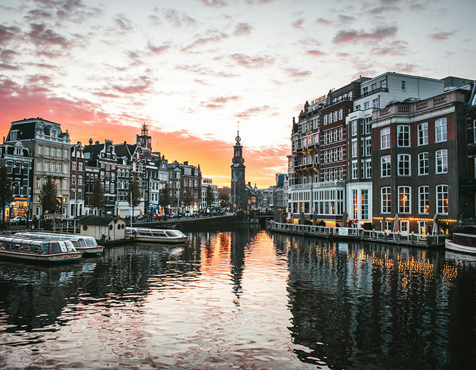 Amsterdam, buildings surround a river with boats
