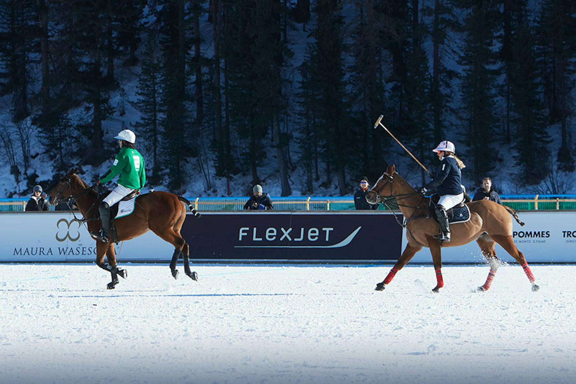 polo players and horses on a snow covered field