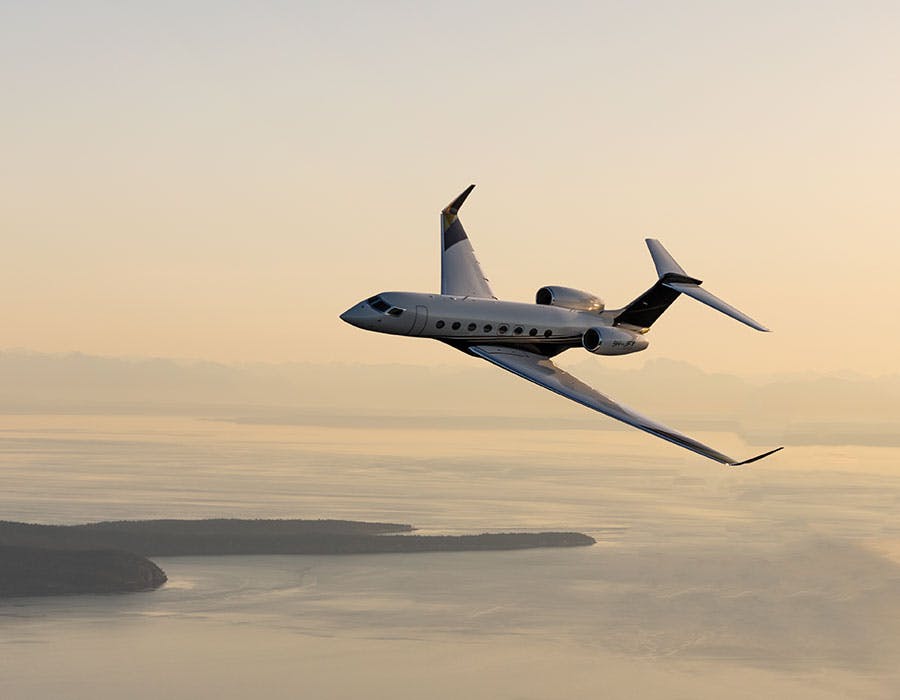 g650 flying above clouds and islands