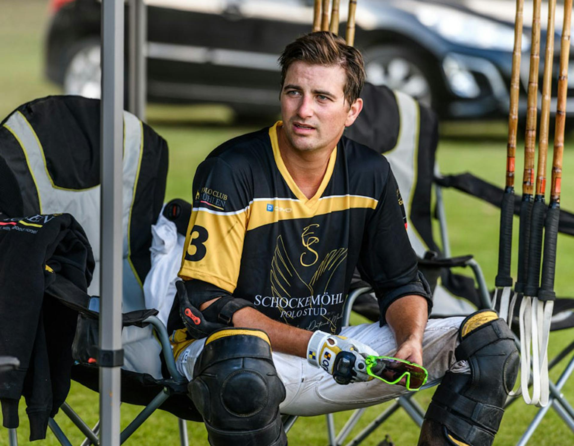 Patrick Maleitzke looking off screen sitting in a foldable outdoor chair