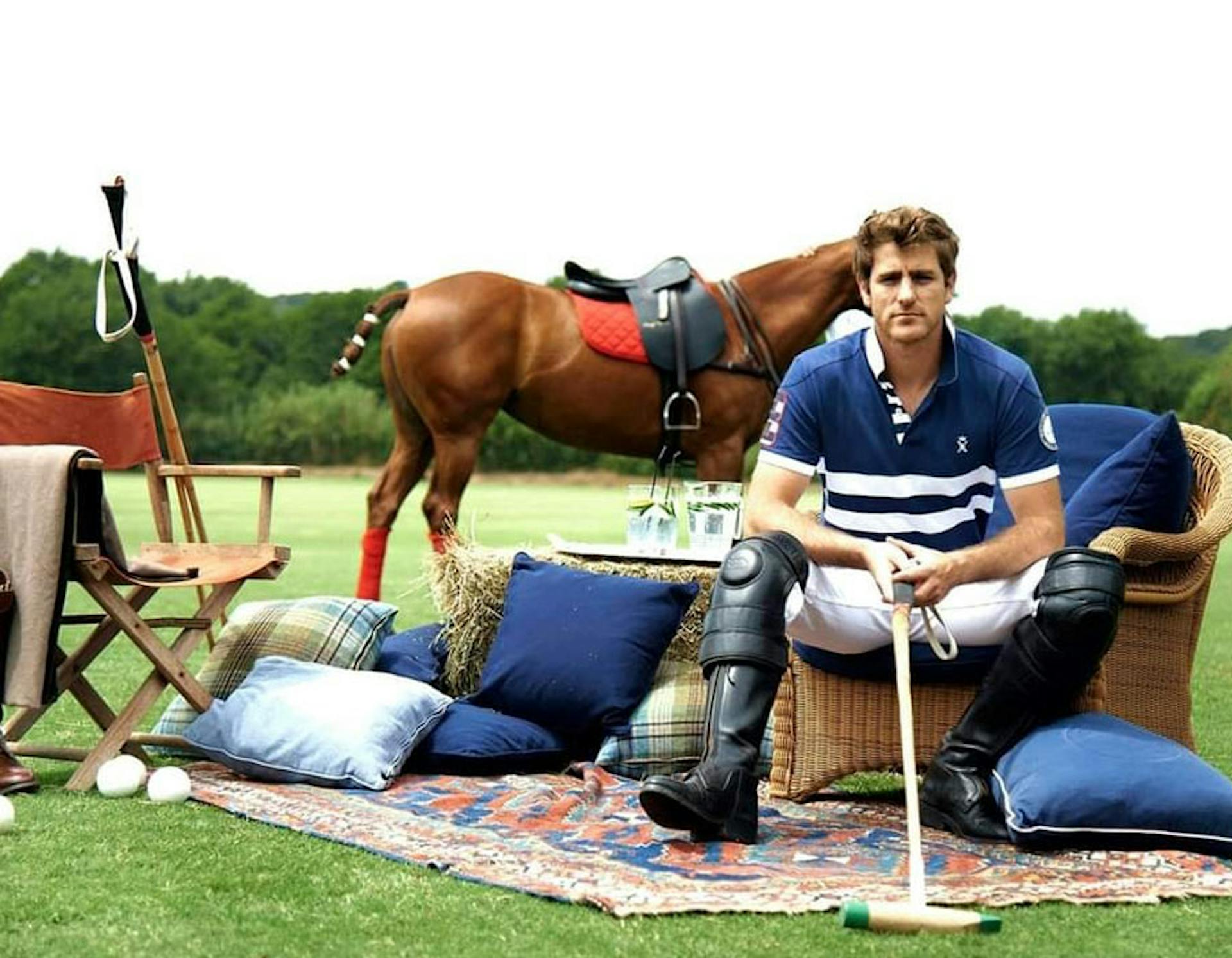 Clément Delfosse in a living room on a chair but set up outside with a horse in the background