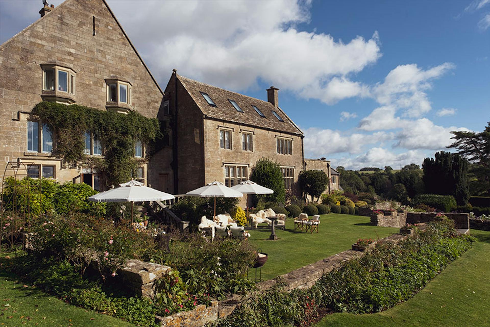 Exclusive Cotswold Estate yard, patio, tables and umbrellas
