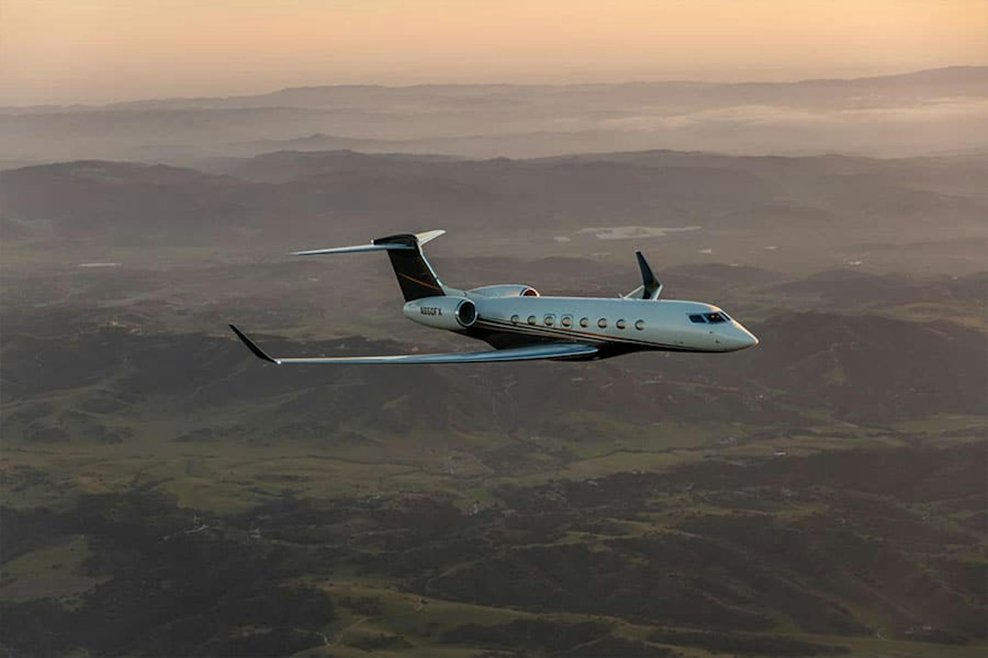 flexjet aircraft flying over rocky hills