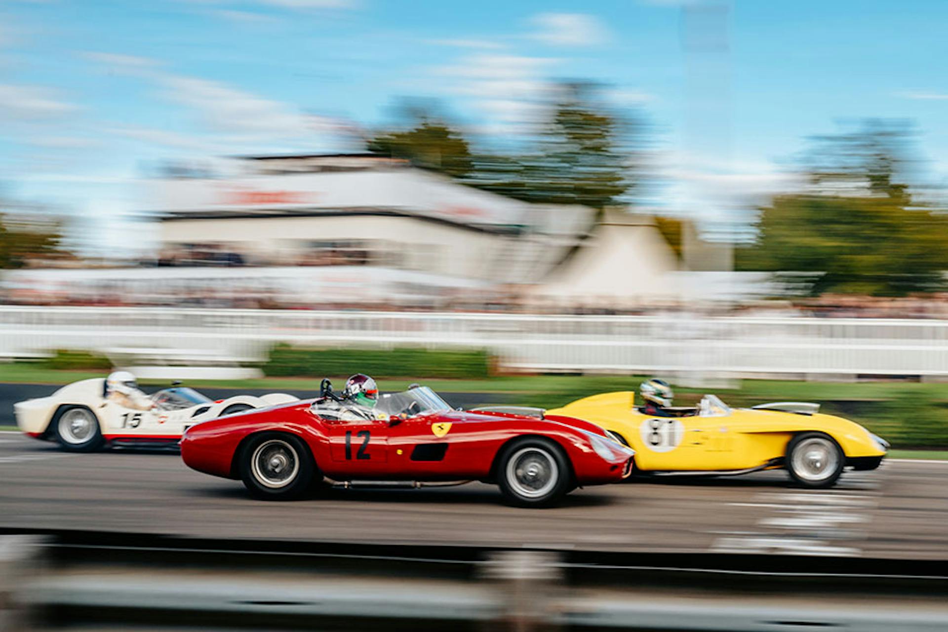 race cars driving with the background blurred