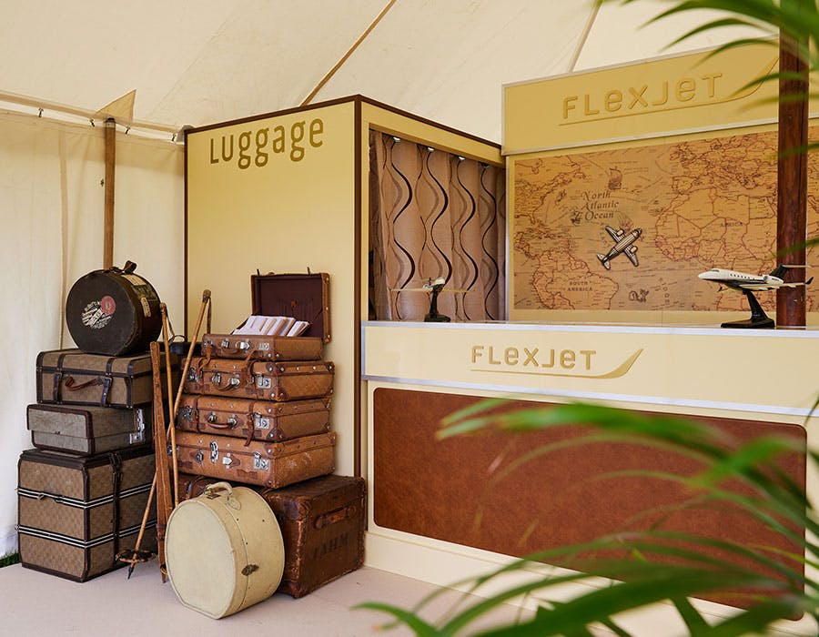 luggage stacked up at a flexjet event tent