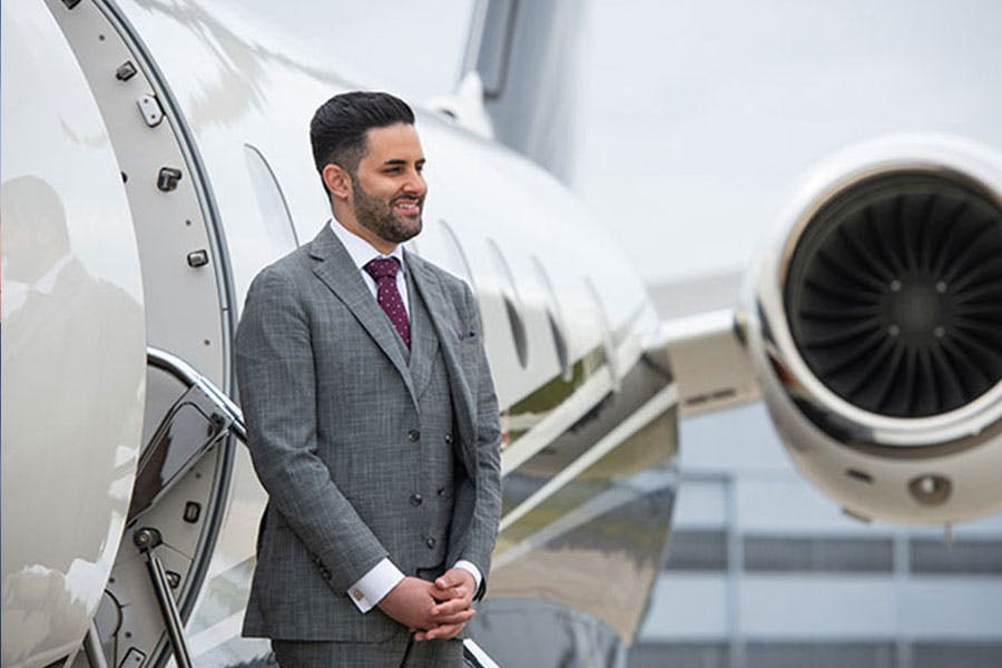man standing in front of a private jet