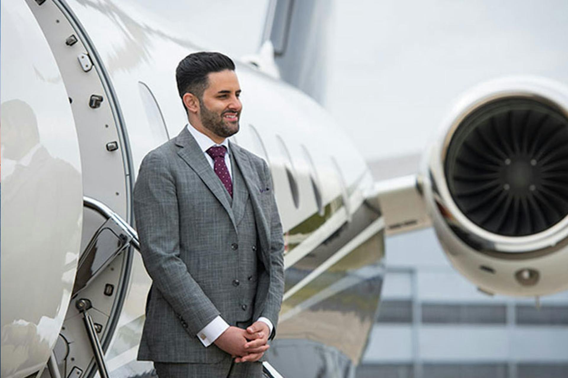 man standing in front of a private jet