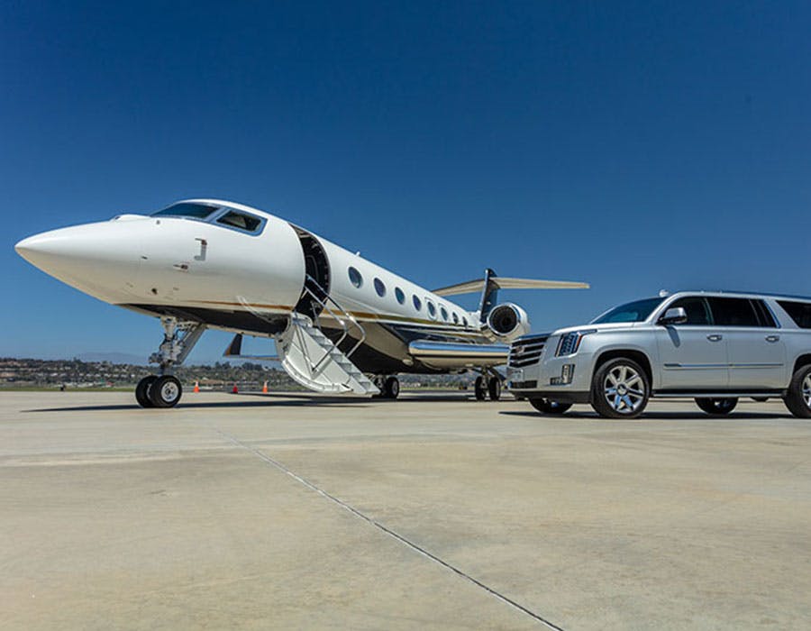 private jet and car parked next to each other