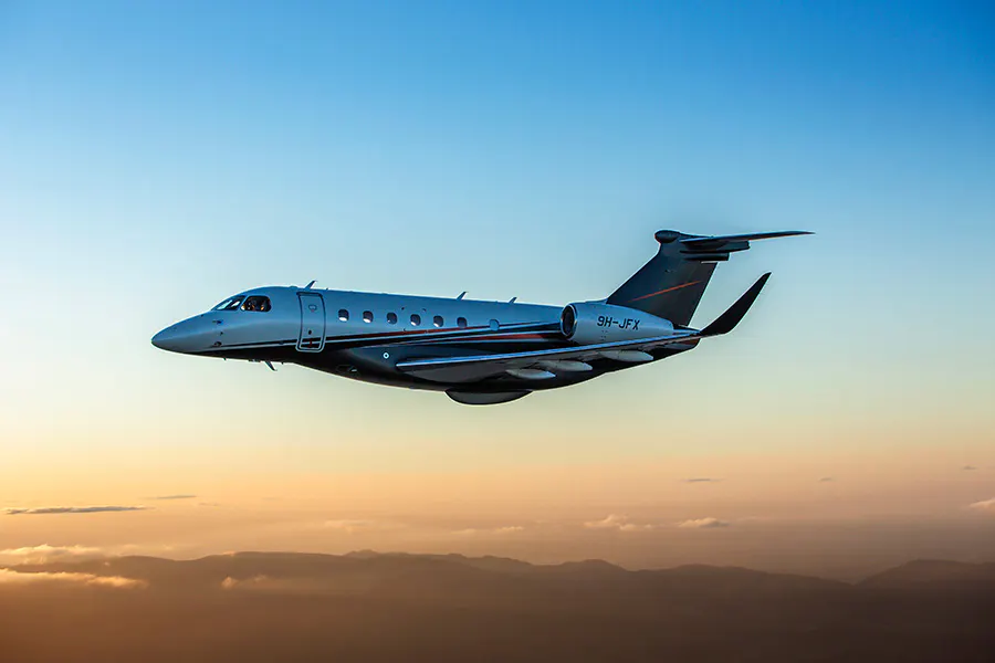 A Praetor 600 flying at golden hour