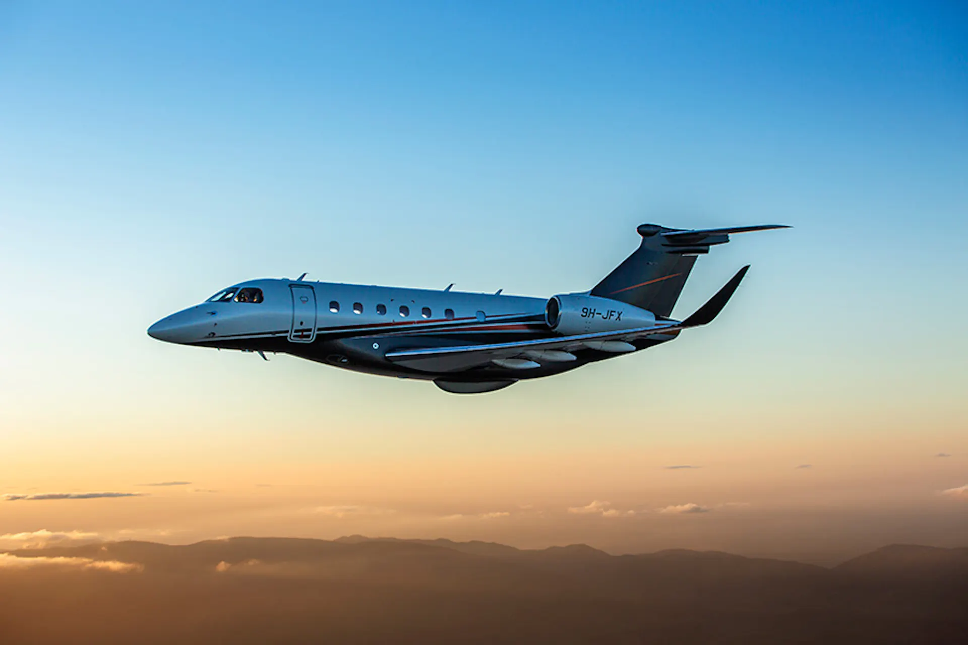 A Praetor 600 flying at golden hour