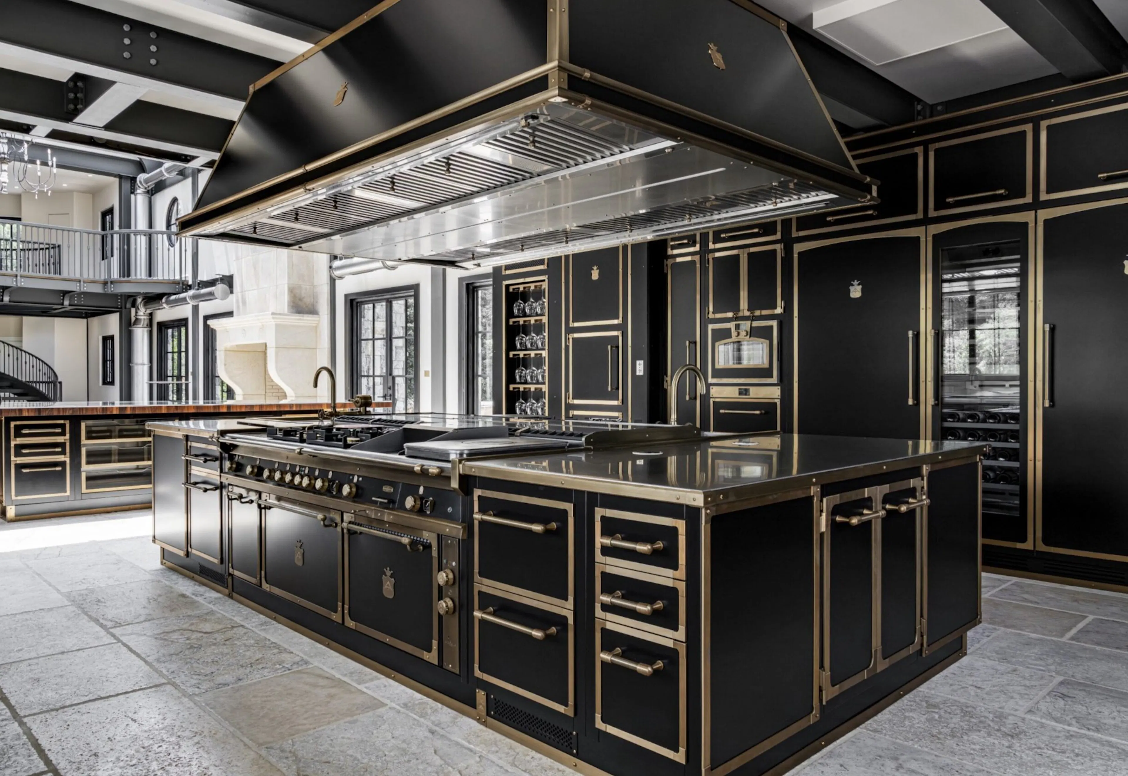 Classy dark cabinets and gold accents in a large, custom kitchen