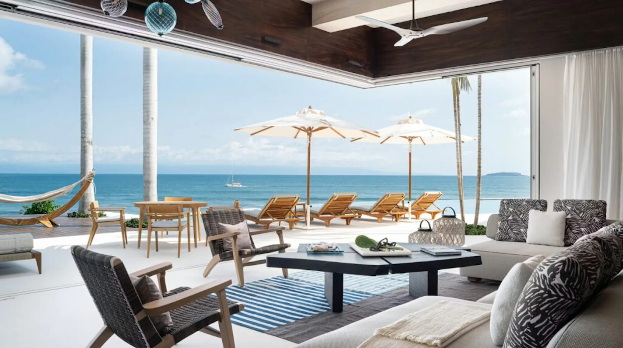View from a luxury rental home one the beach with lots of furniture for relaxation