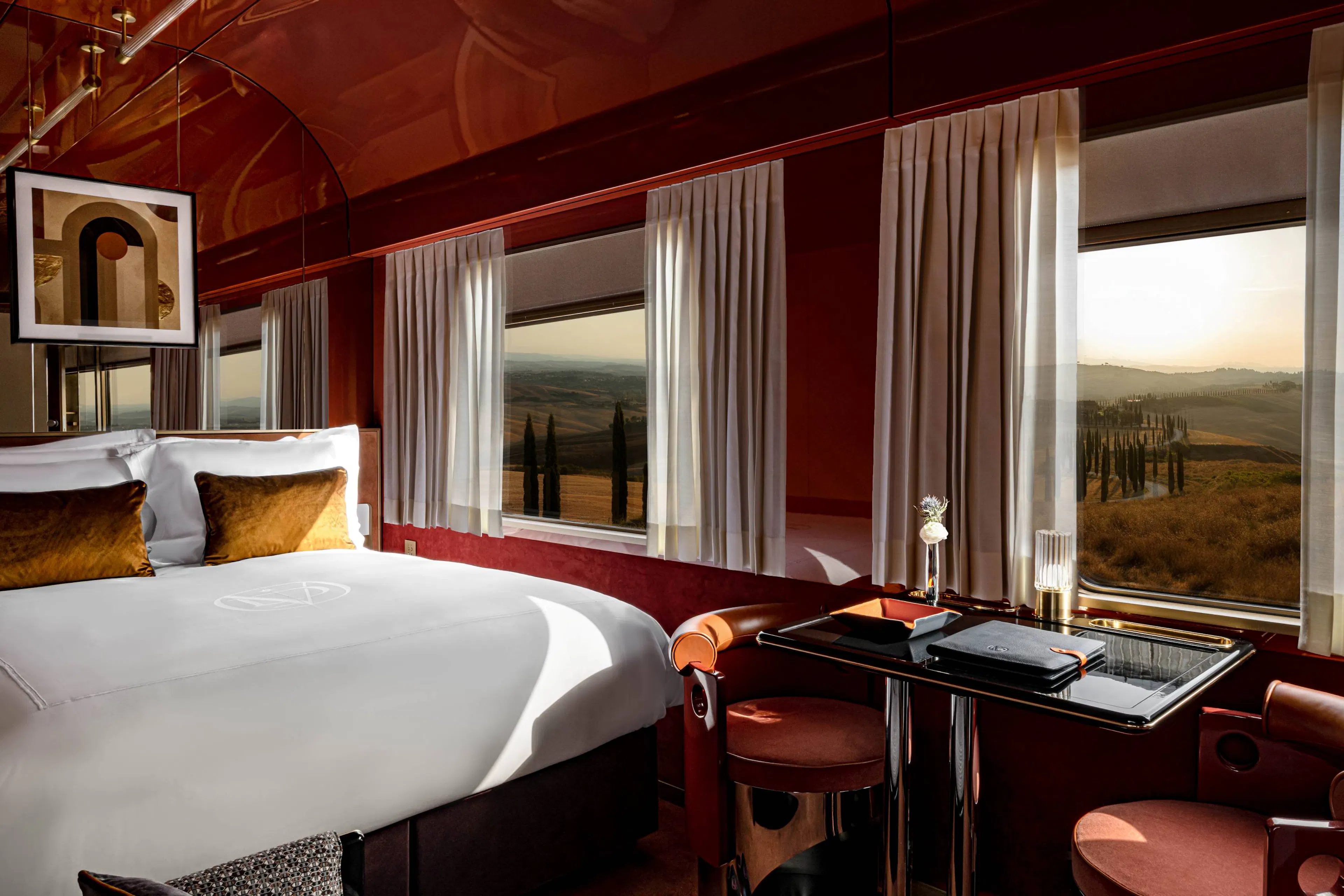 Luxury train car room with bed table and chairs with unique landscape views from the windows