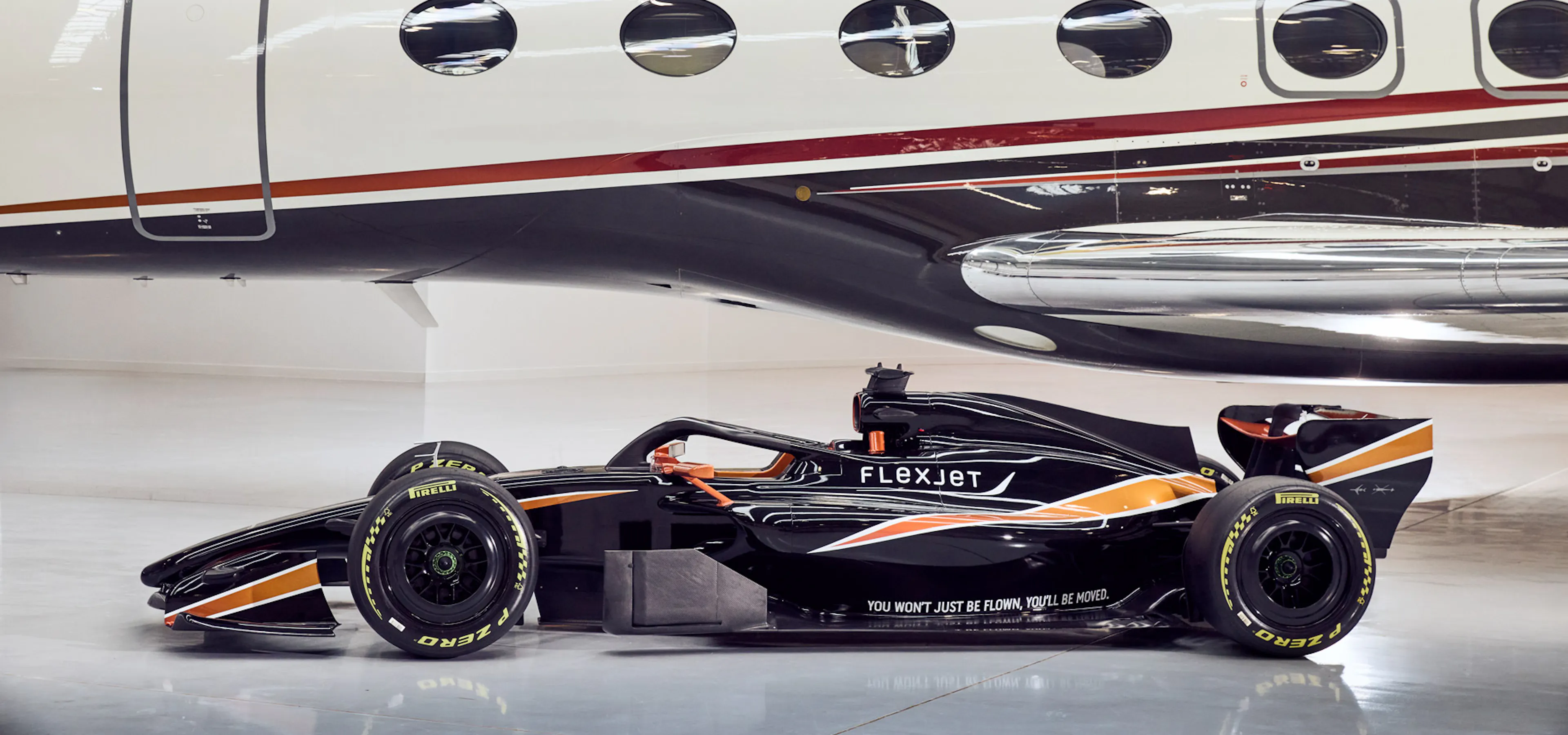 Flexjet branded F1 car with a FlexJet behind it