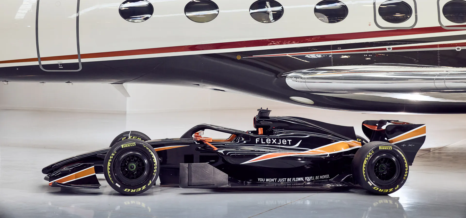 Flexjet branded F1 car with a FlexJet behind it