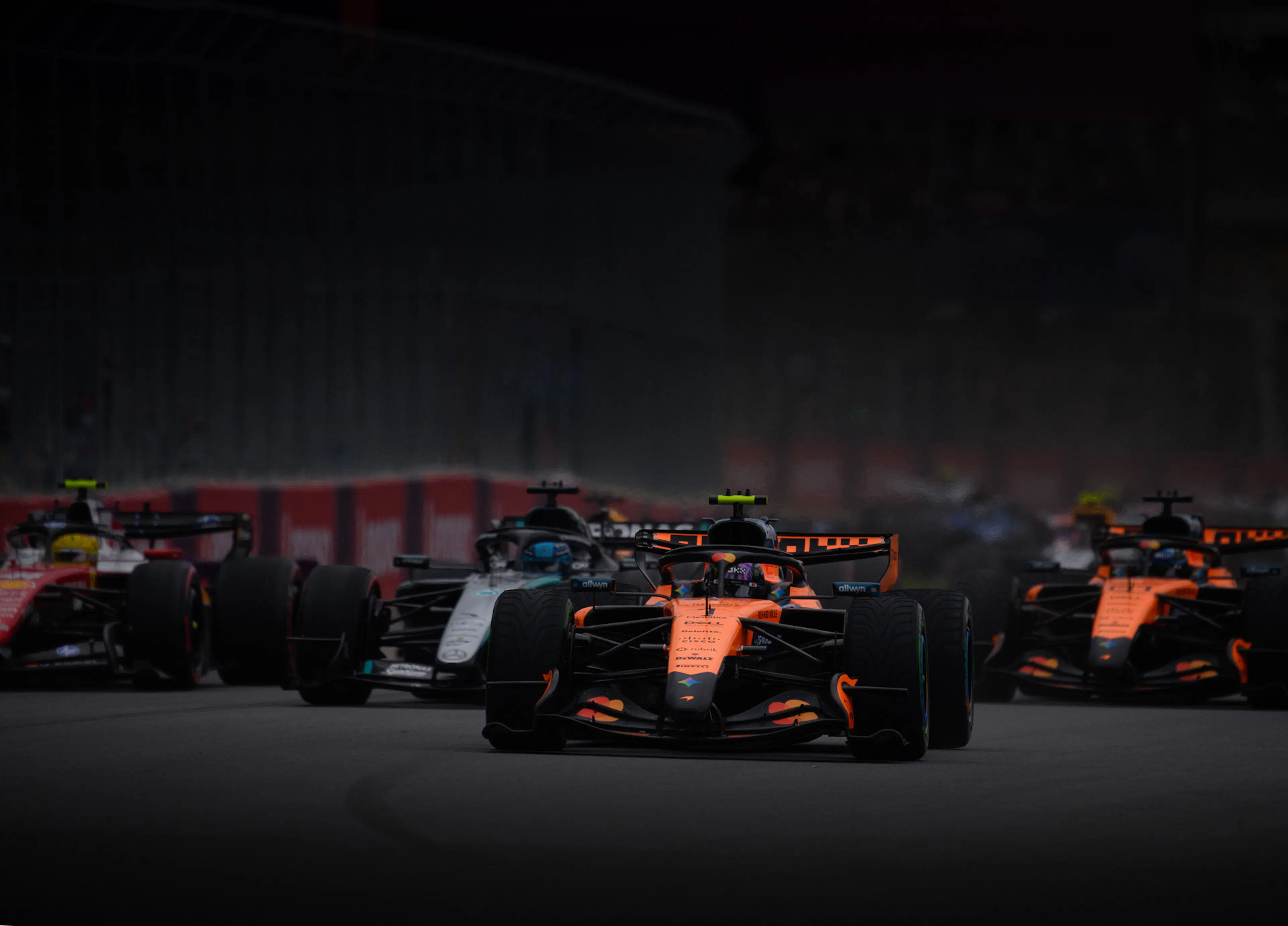 A series of F1 cars on track