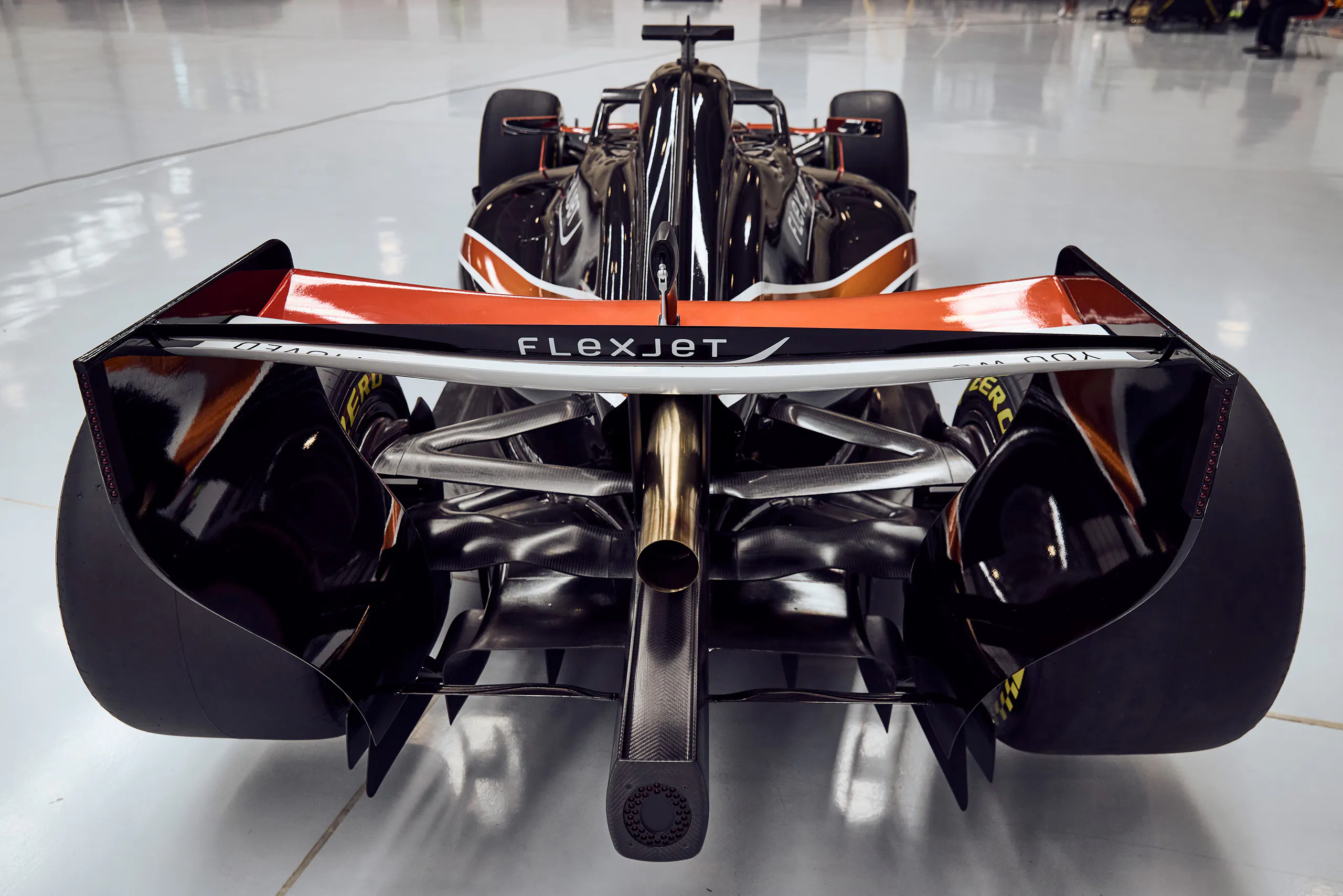 Rear view of an open wheel race car with Flexjet on the wing