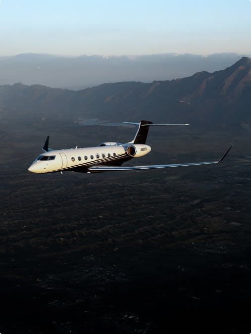 g 650 flying over the valley with mountains in the background