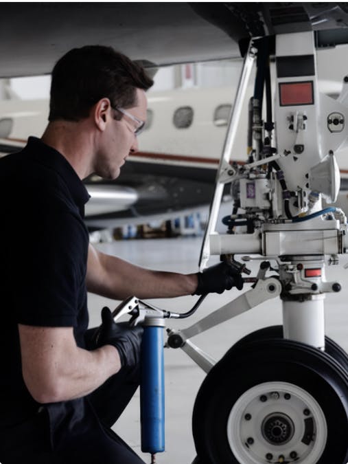a man inspects landing gear
