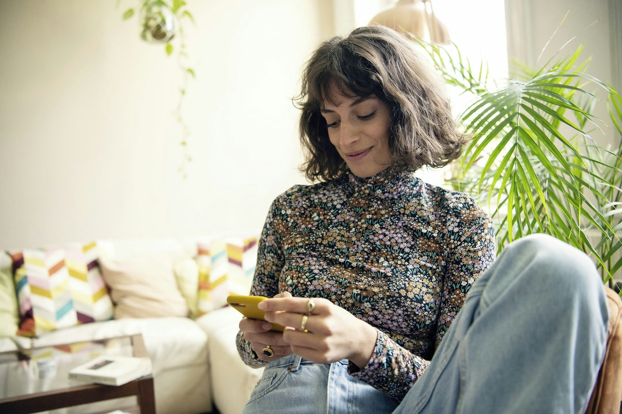woman using smartphone and smiling