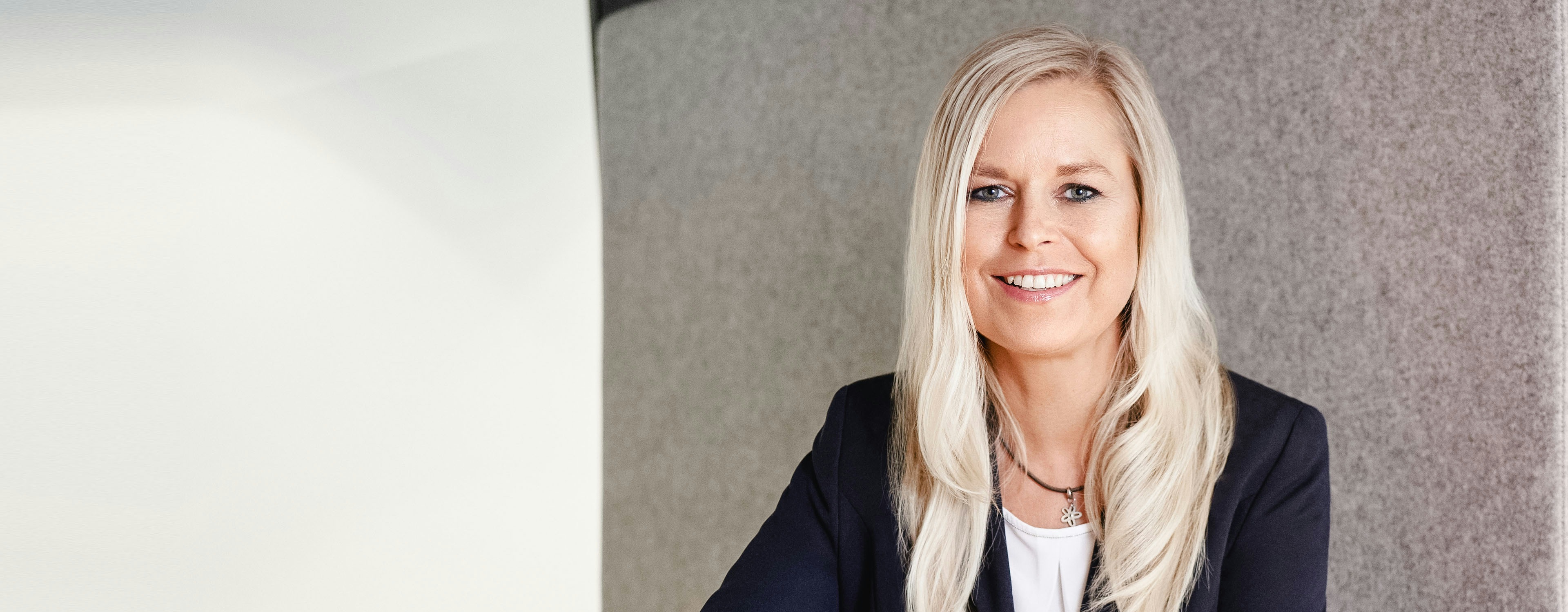 Sandra Mühlhause smiling at a desk