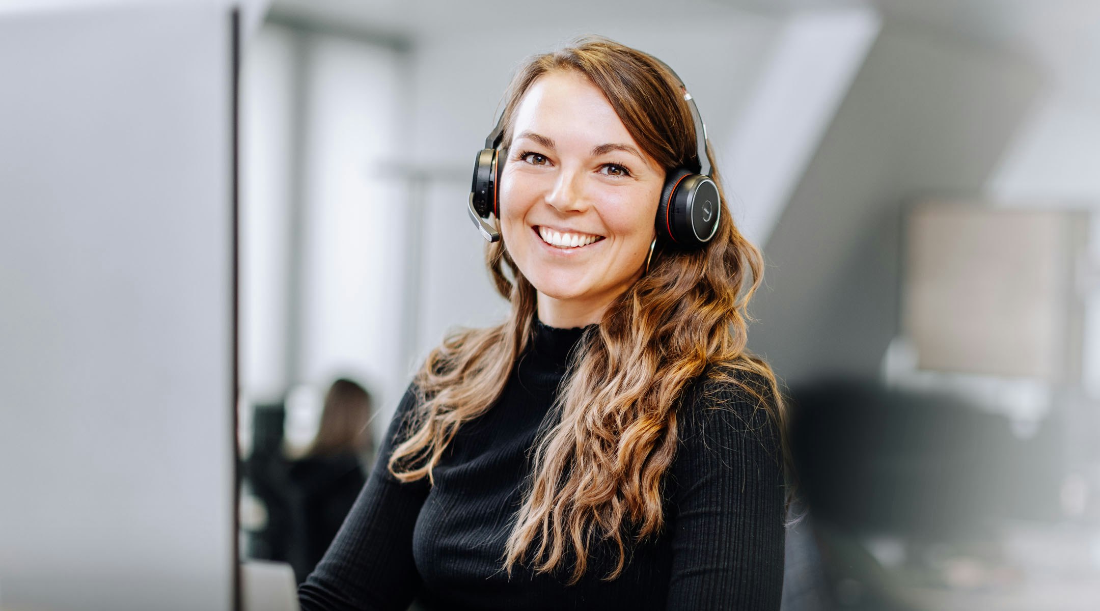 Woman in black pullover with headset