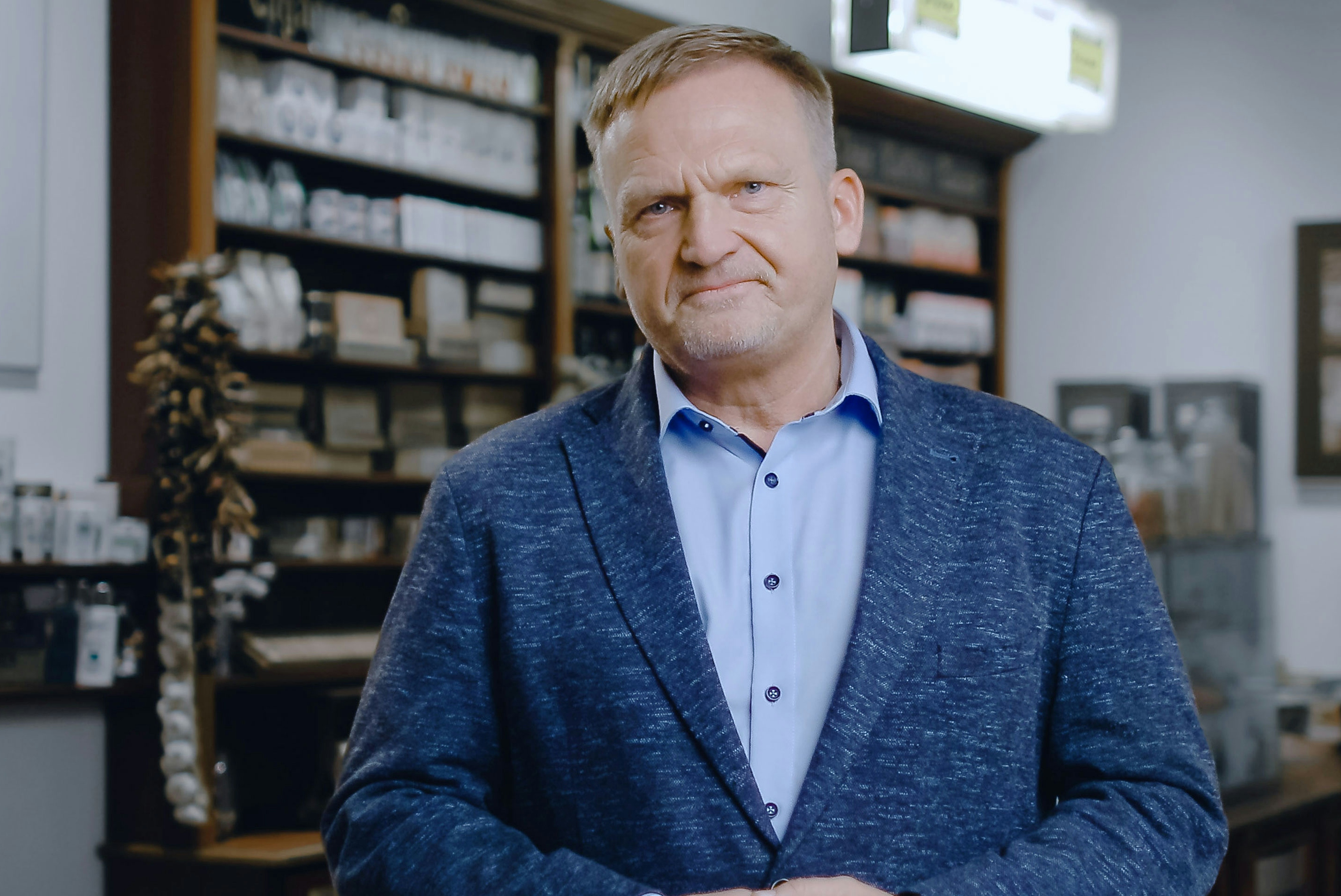 Peter Maly managing Director of REWE wearing a blue suit