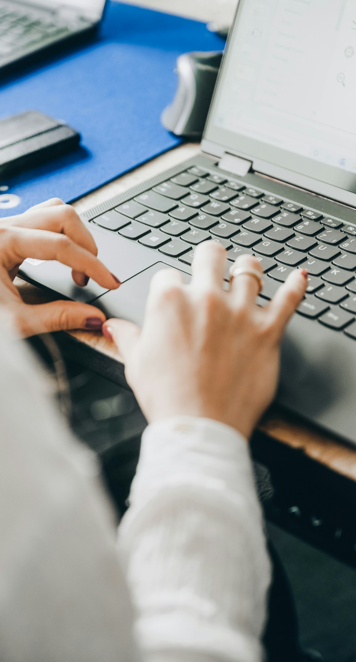 Person typing on laptop keyboard