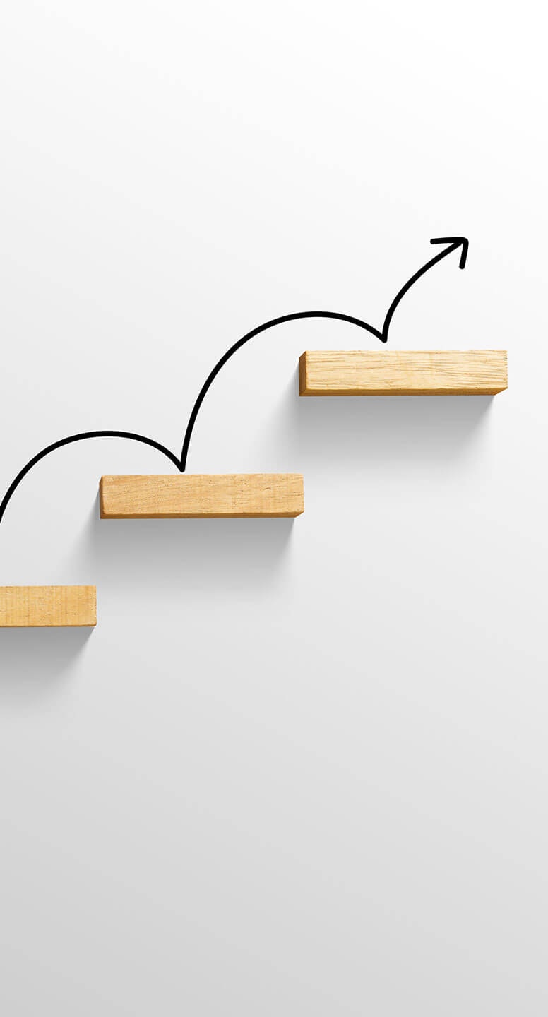 Wooden boards arranged as stairs with a black arrow hopping up them