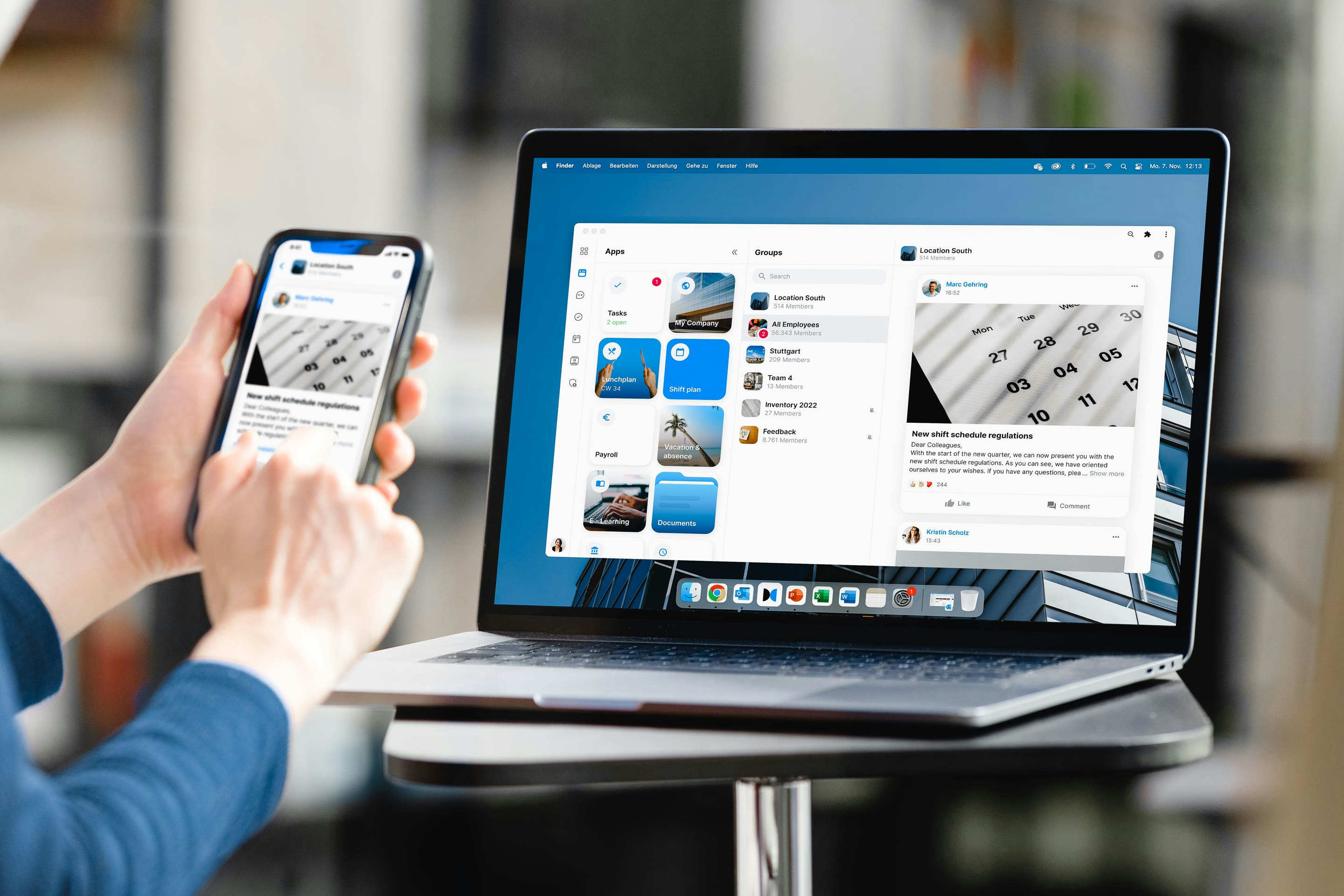 Person sitting on chair, on table laptop with mockup and mobile phone in hand