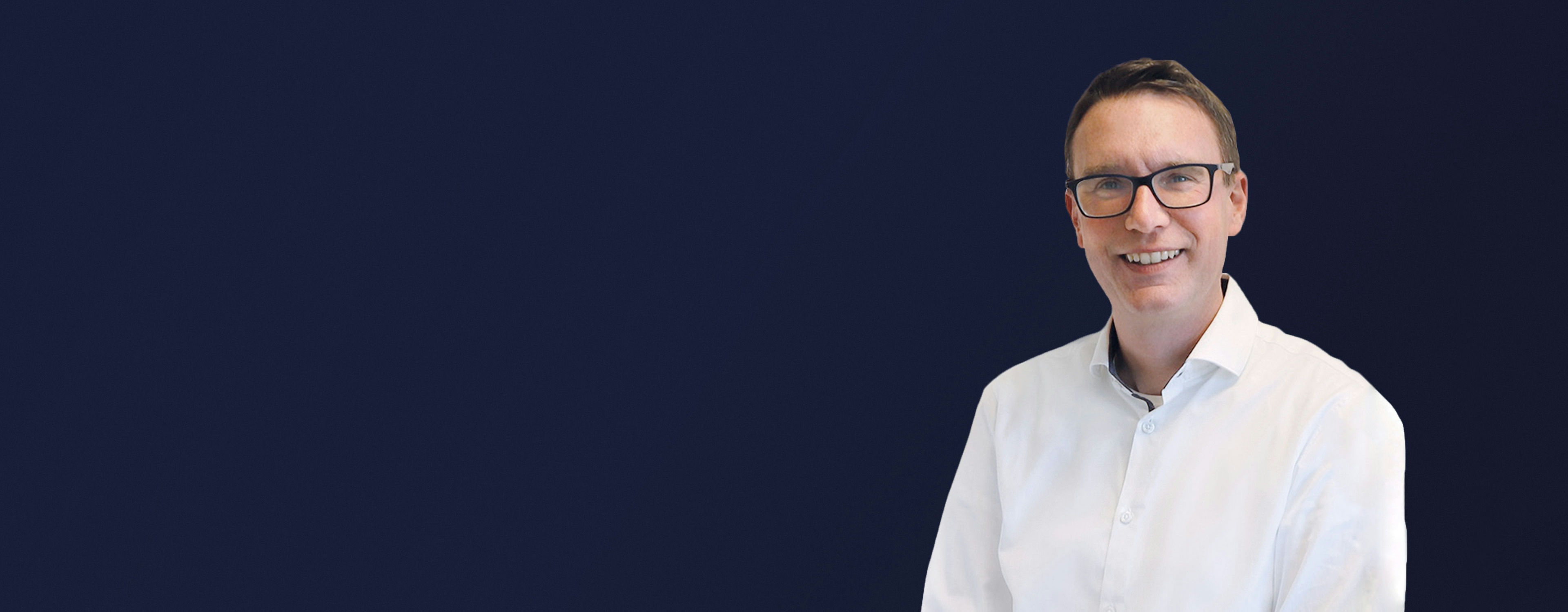 Frank Lobert from KODI in white shirt and glasses smiling