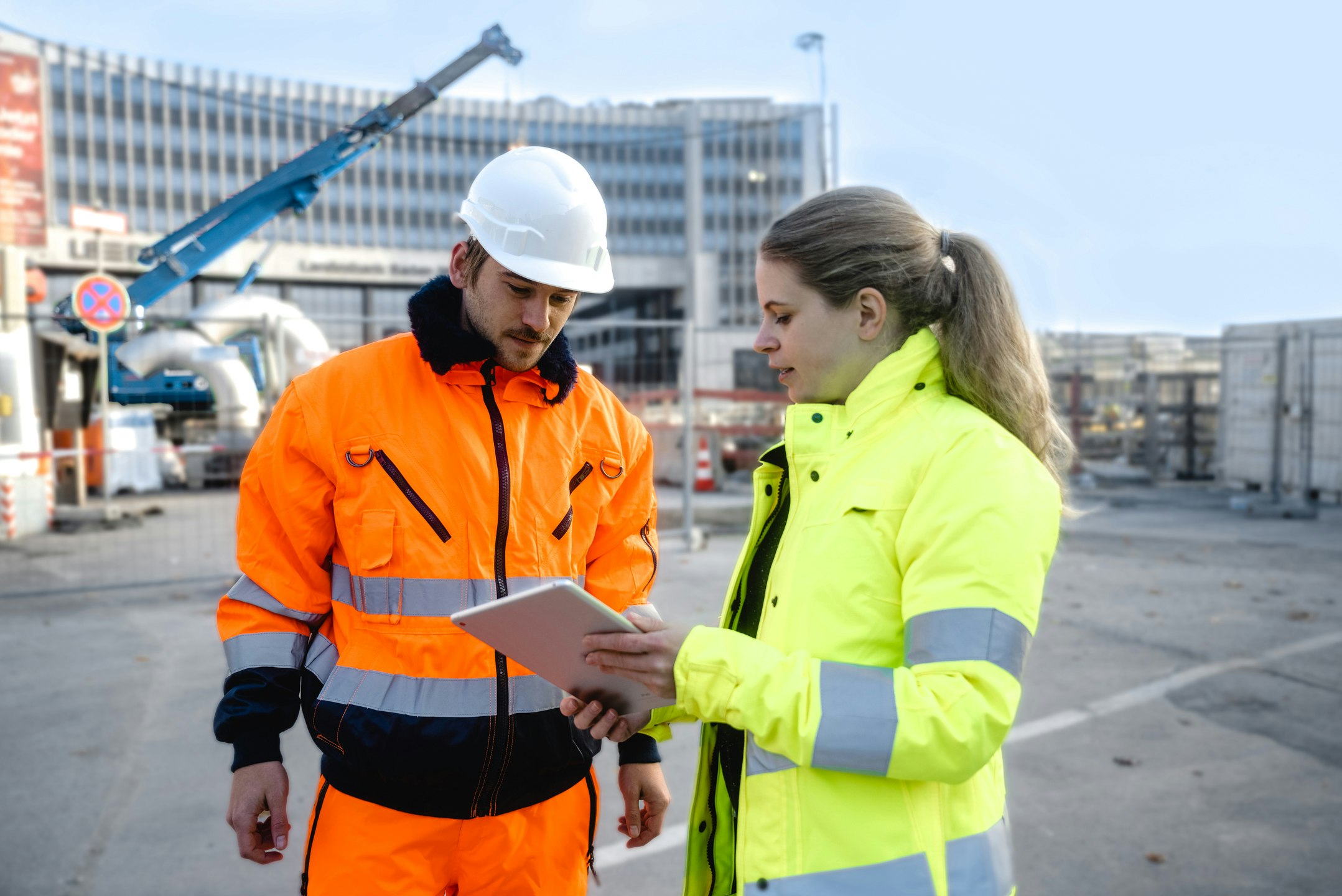 Two construction worker in front of building site