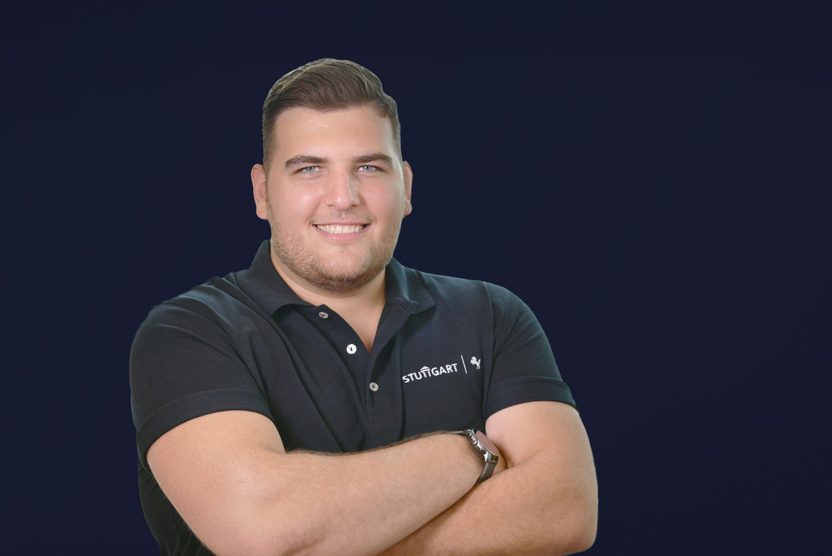 Maximilian Hubl from the City of Stuttgart smiling into the camera wearing a black polo shirt