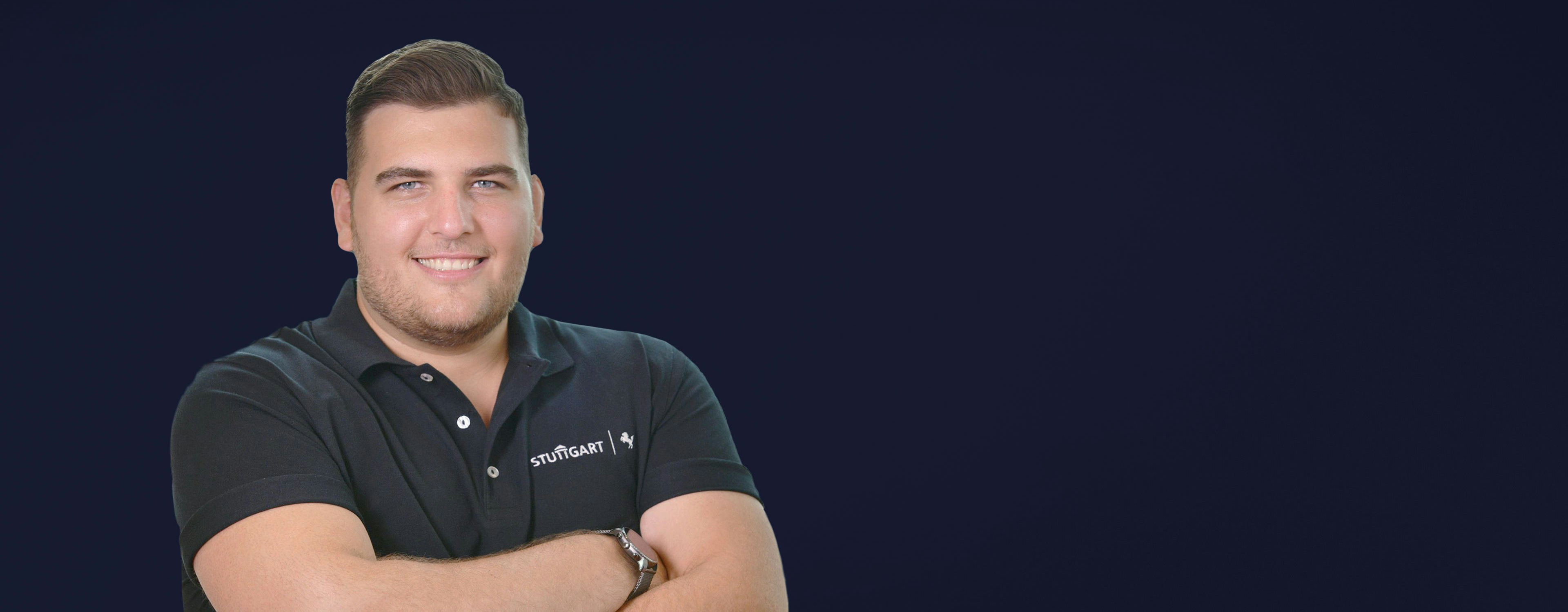 Maximilian Hubl from the City of Stuttgart smiling into the camera wearing a black polo shirt