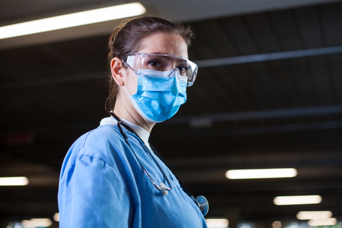 Healthcare worker in goggles and mask