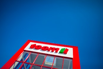 Blue sky and red toom building with logo