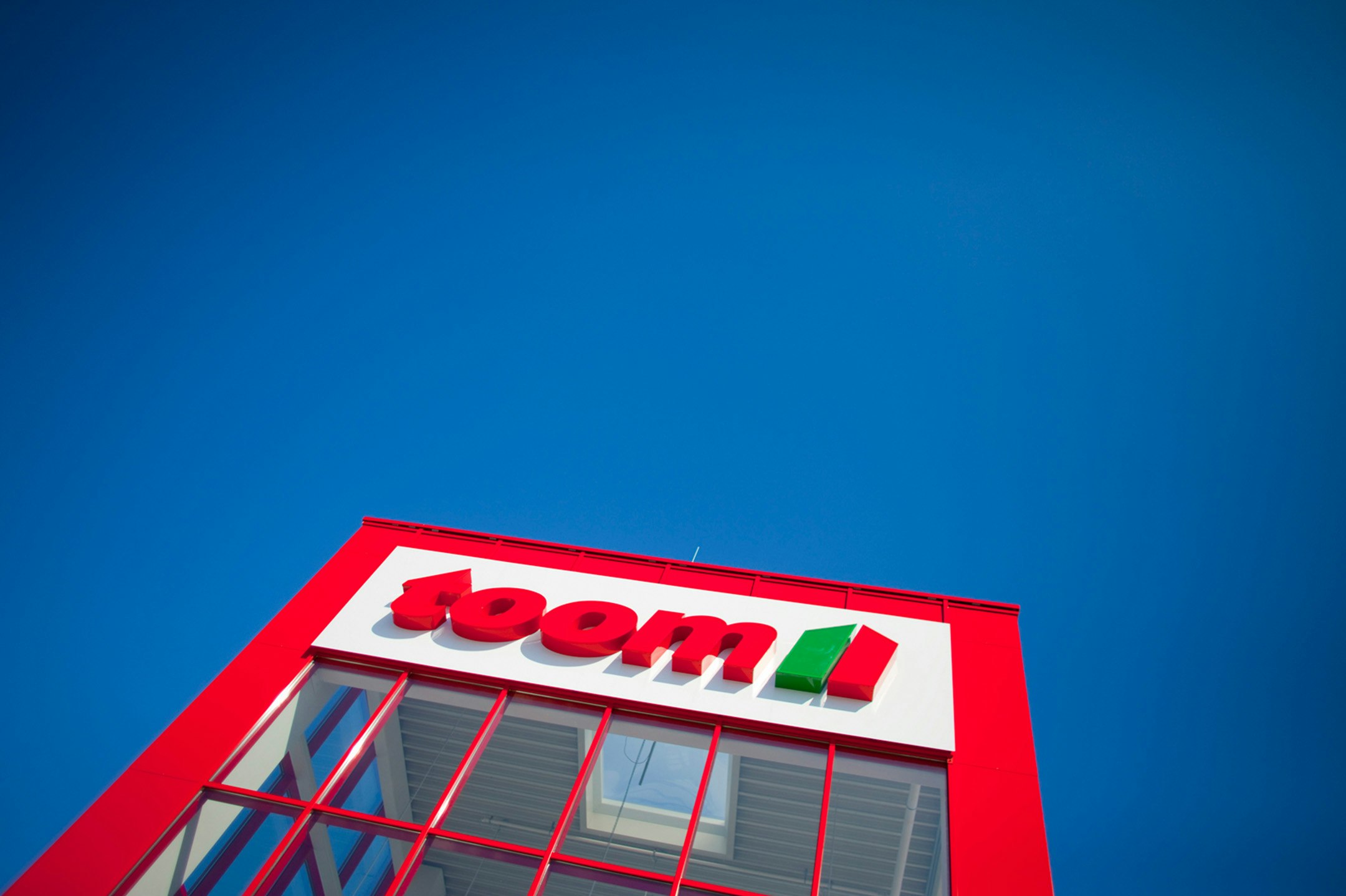 Blue sky and red toom building with logo