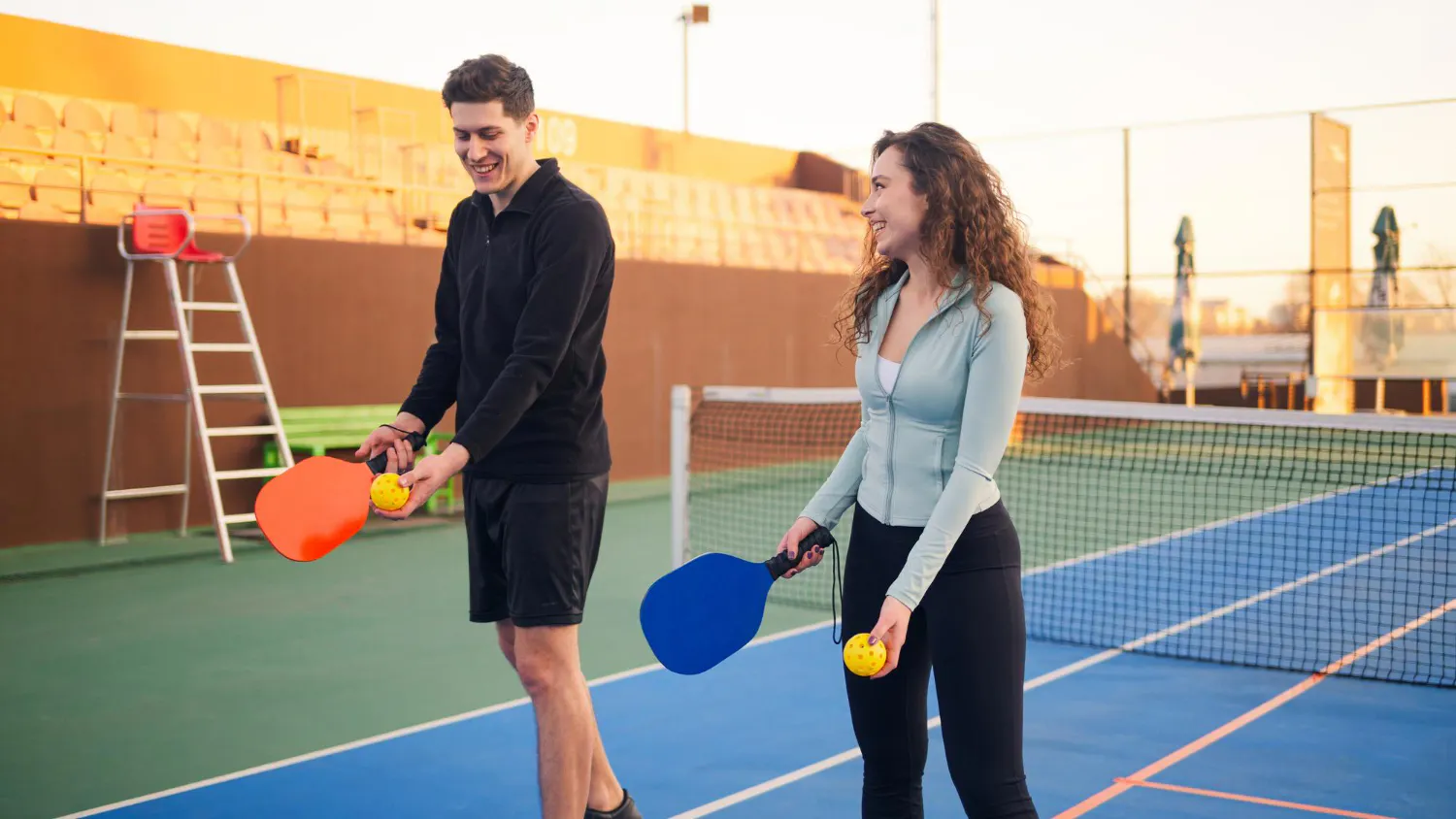 Man and woman practicing pickleball