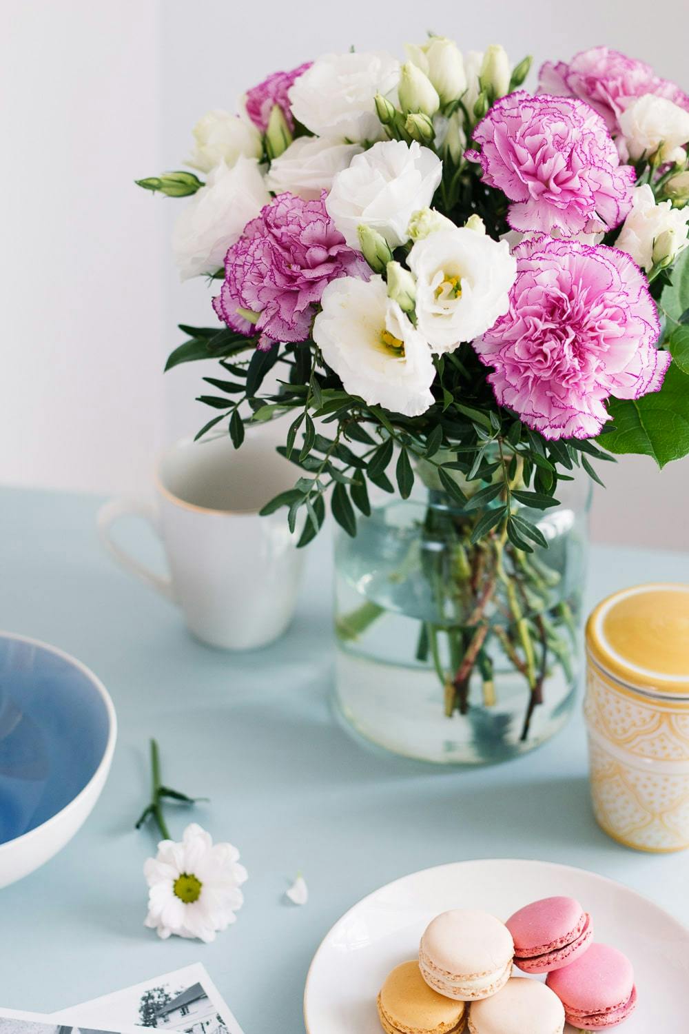 pink carnation and white lisianthus bouquet on breakfast table