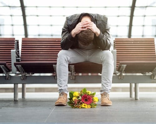 man with head in his hands bouquet