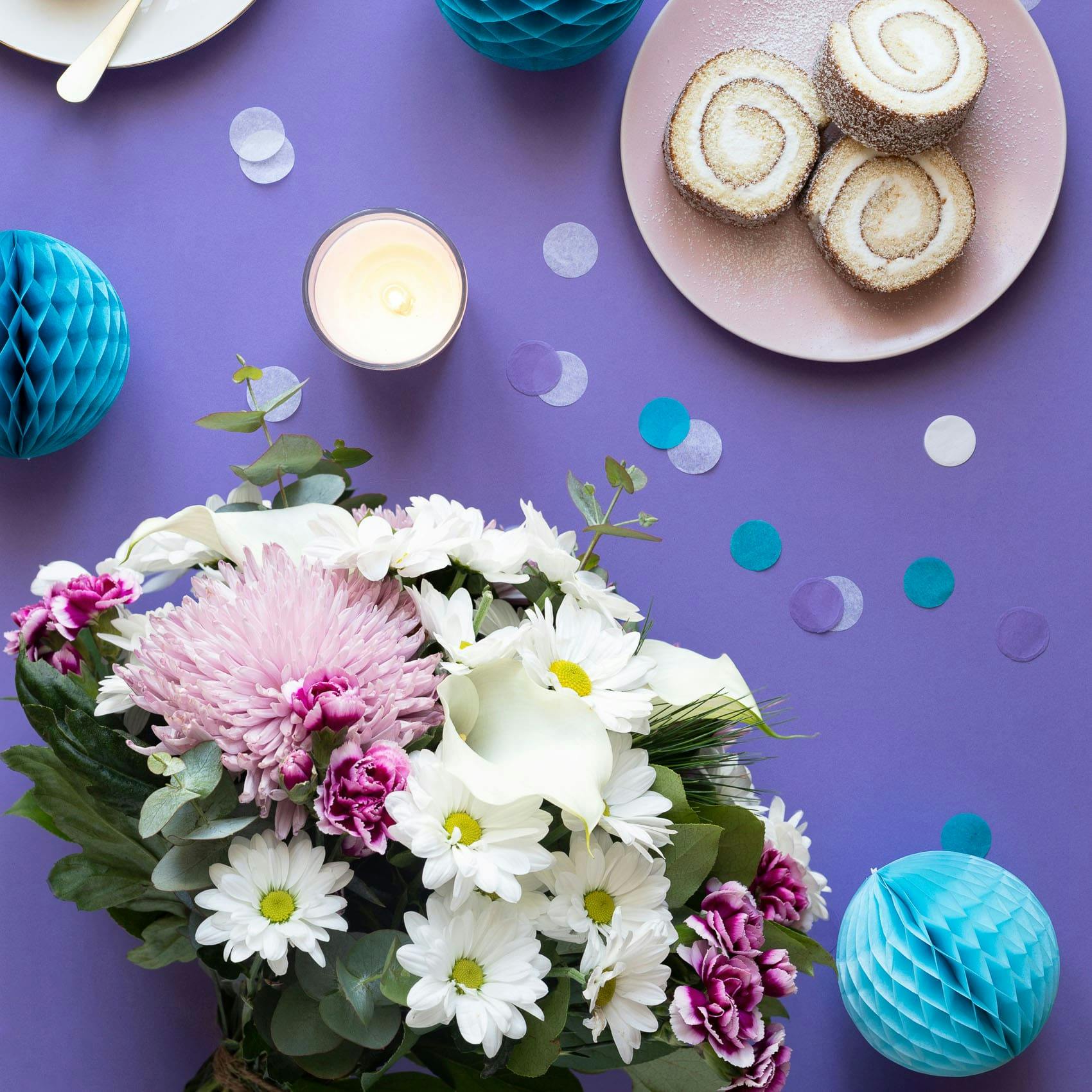 serendipity bouquet on table with cake