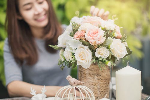 Happy lady arranging flowers