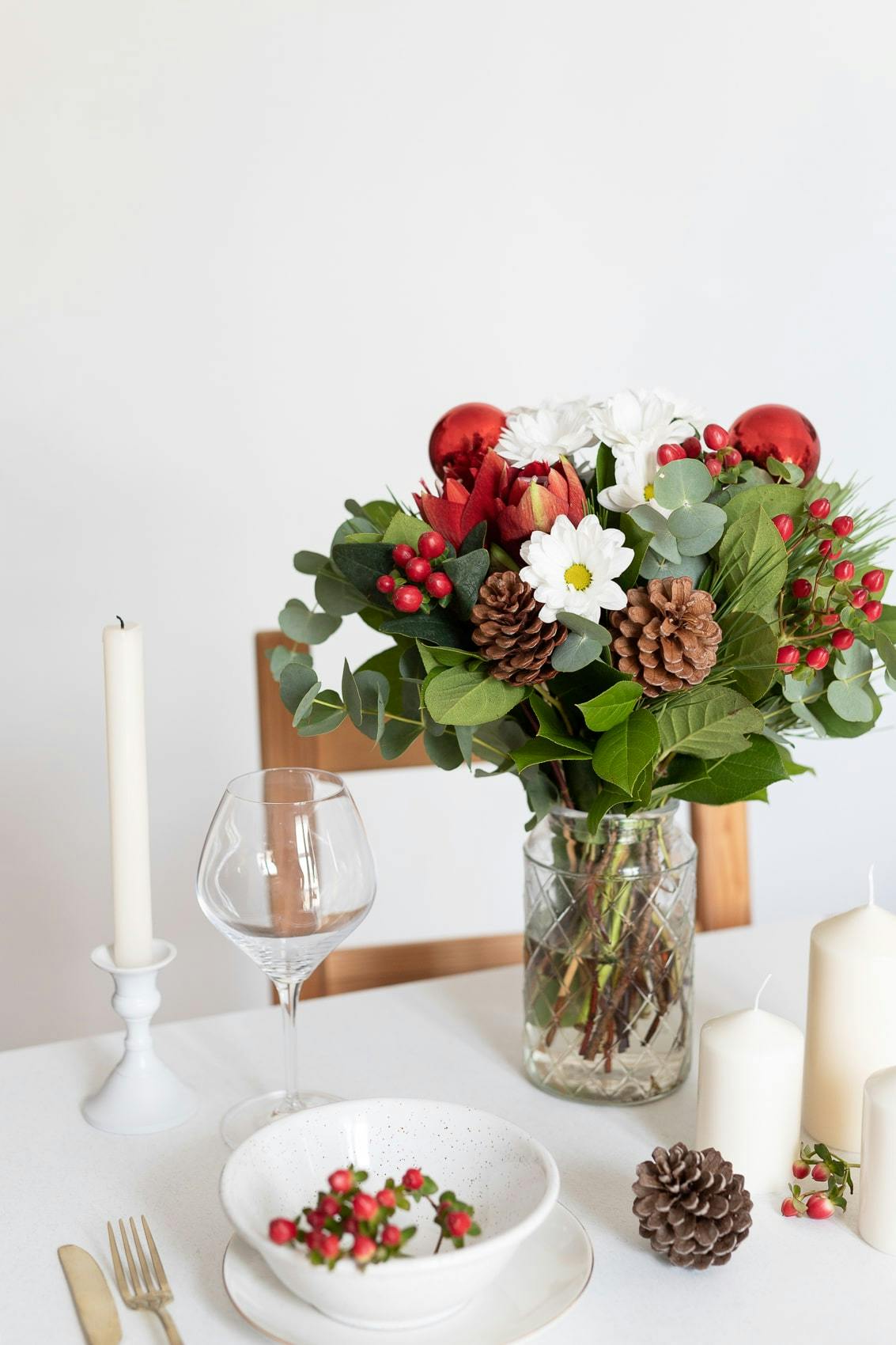 Festive bouquet of pinecones carnations and red lilies