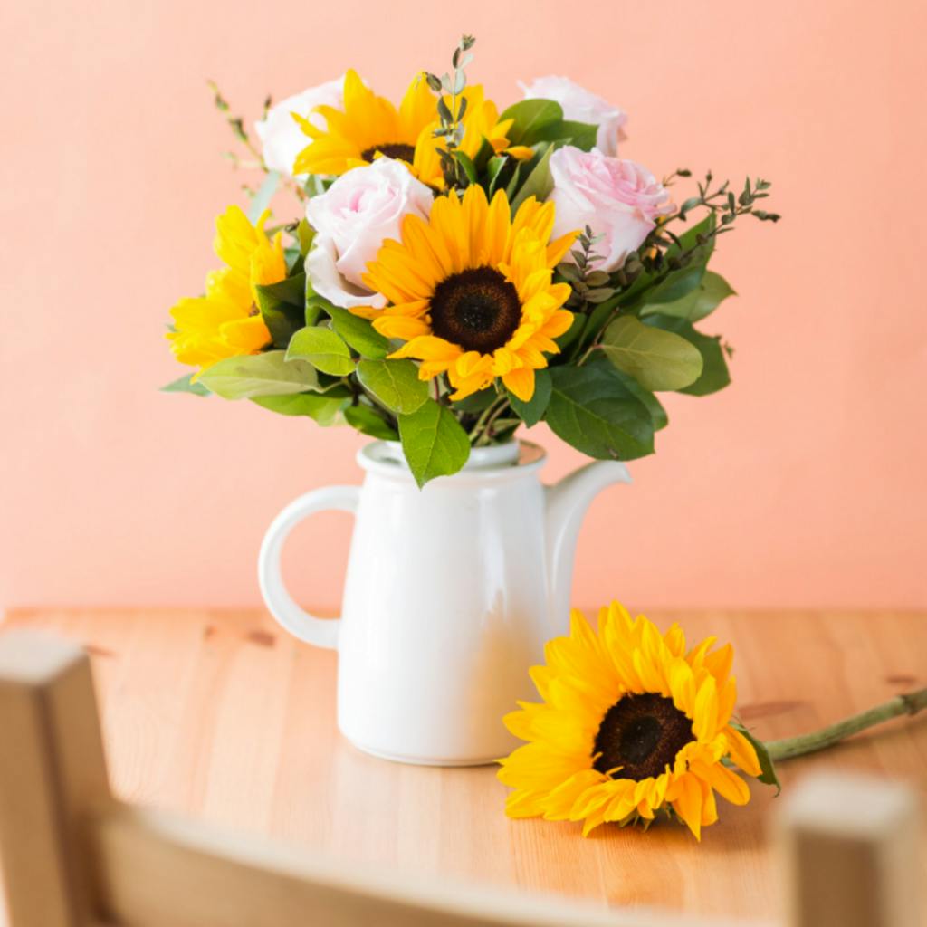 sunflowers and roses in a jug