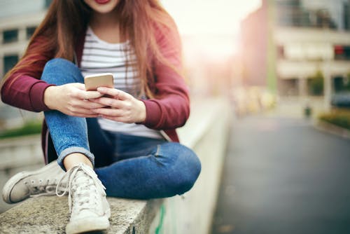 Girl texting on street