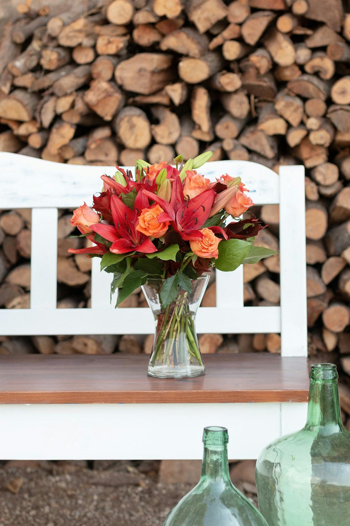 autumnal splendour bouquet in front of logs