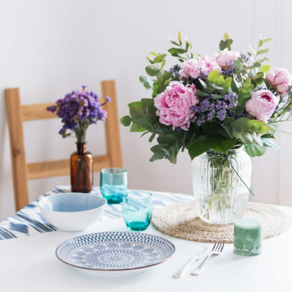 Pink peonies in vase on table