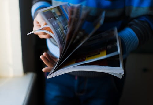 man leafing through a magazine